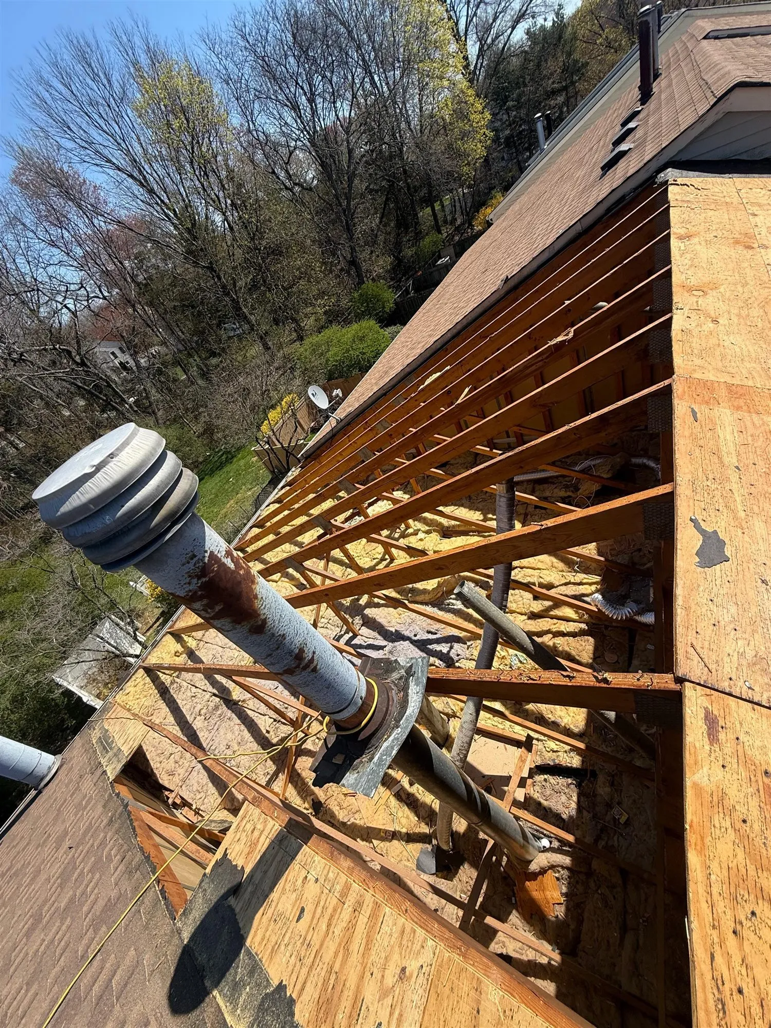 Roof vent pipe on fresh plywood decking before shingles go on