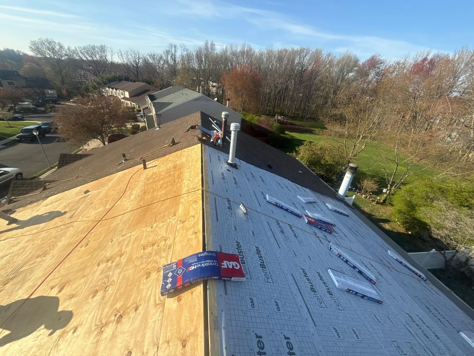 Roof deck with synthetic underlayment and leak barrier installed before the shingles