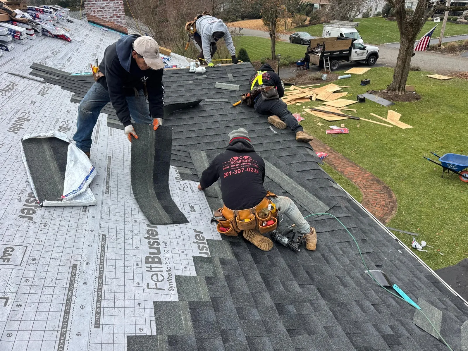 Crew installing new GAF shingles