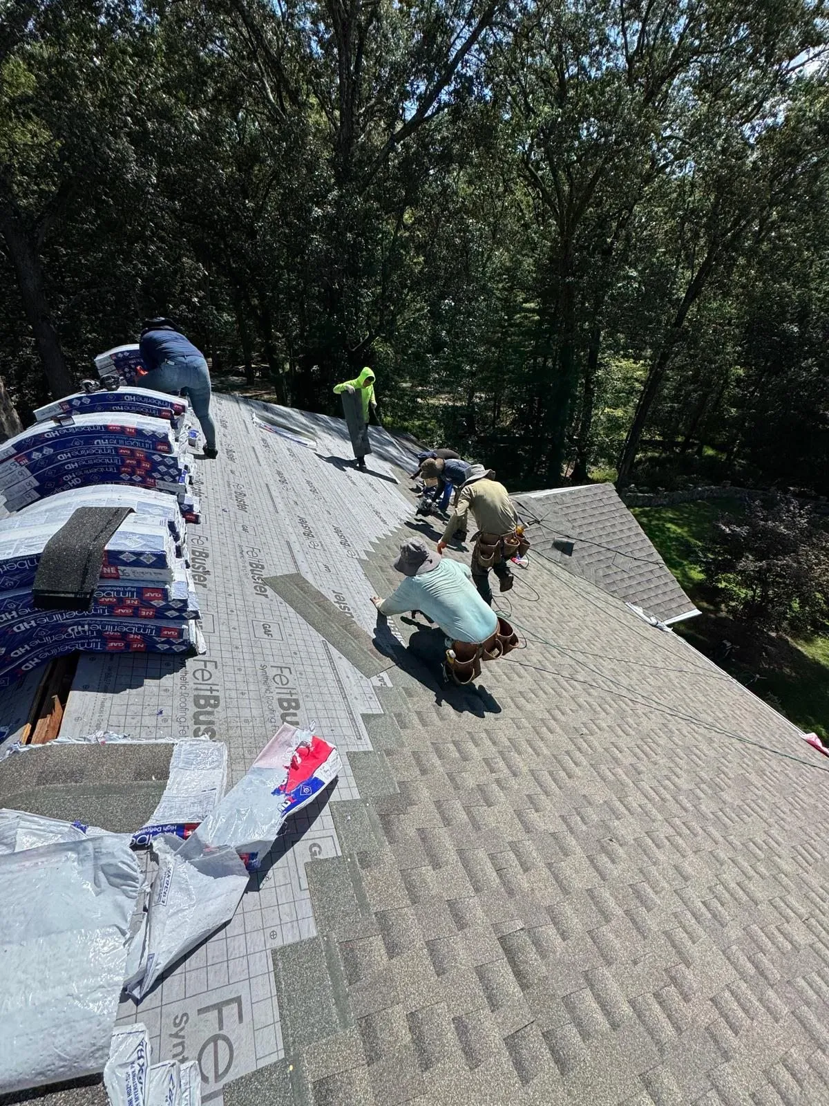 Imperial crew installing shingles from GAF bundles staged on the roof