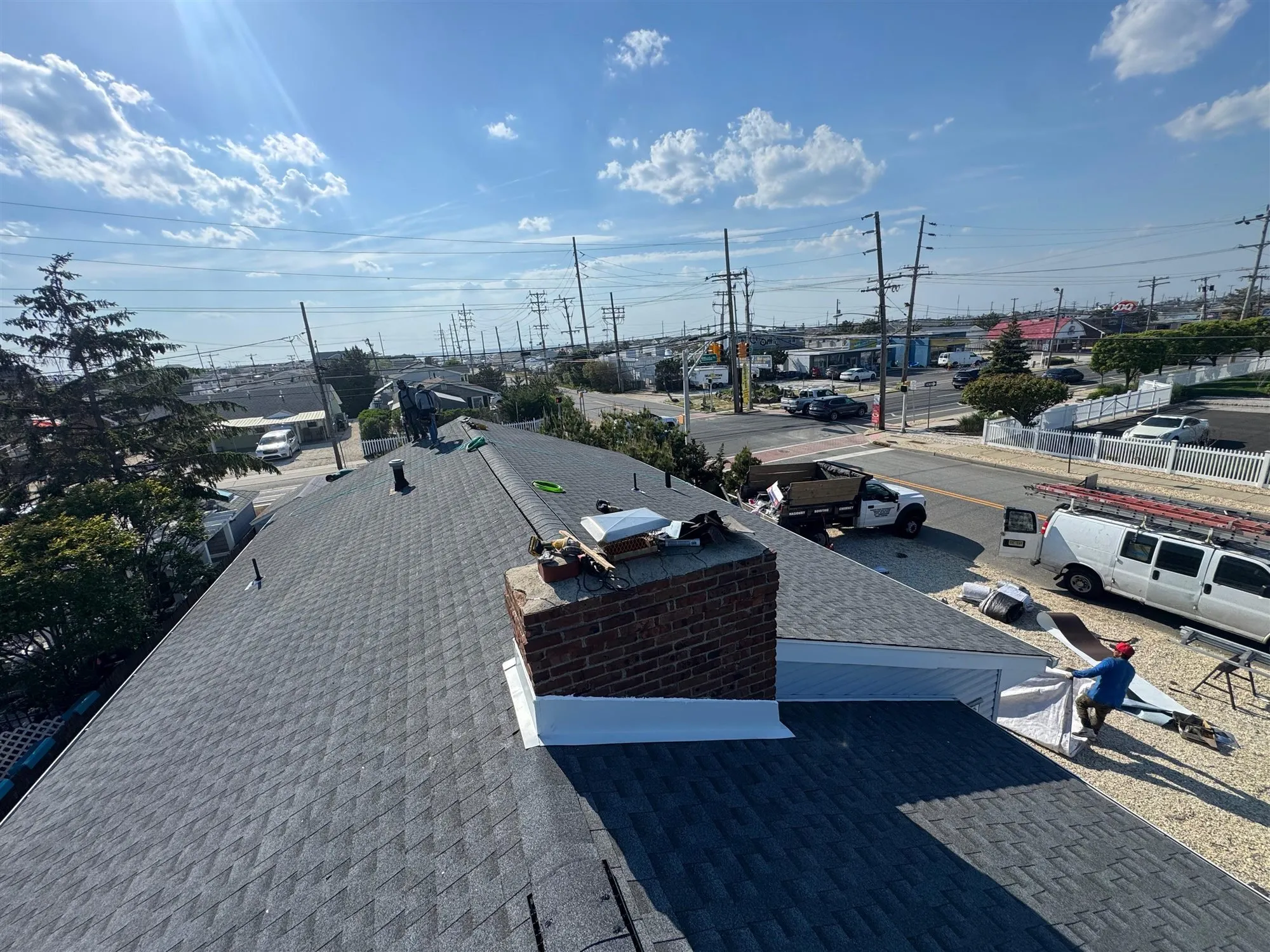 New shingle roof with fresh chimney flashing