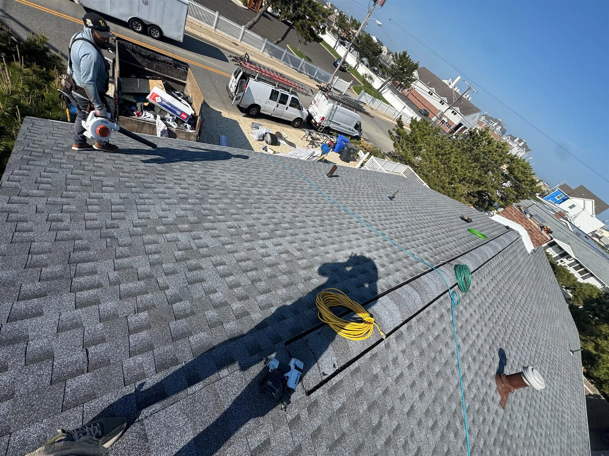 Freshly shingled roof seen from above with the street below