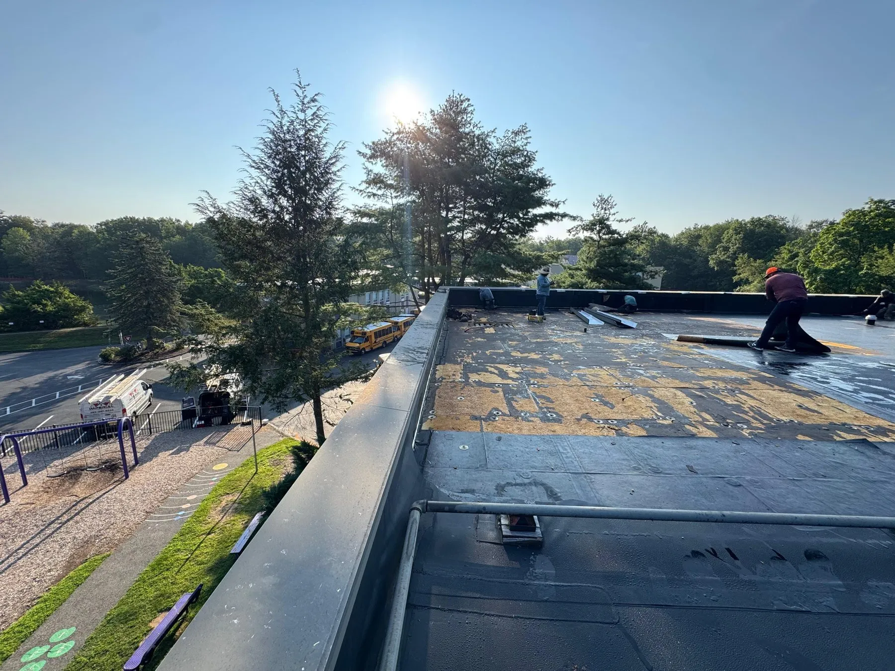 Roofer laying a new membrane over a flat roof