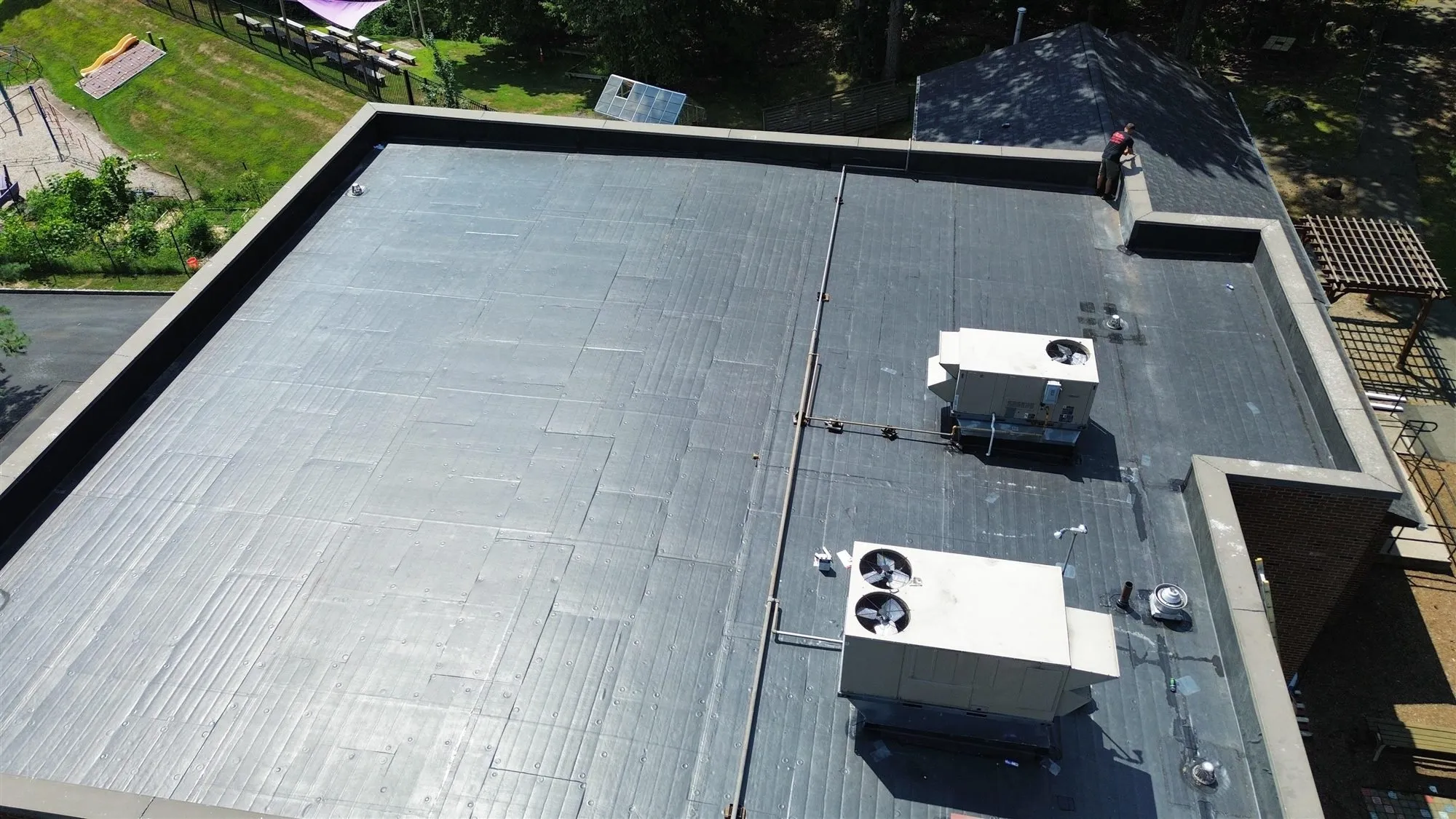 Single-ply membrane flat roof with rooftop HVAC units