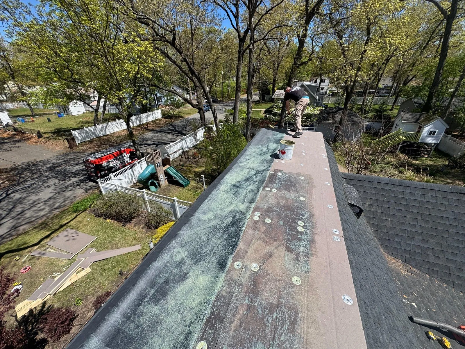 Before: worn, patched low-slope roof section