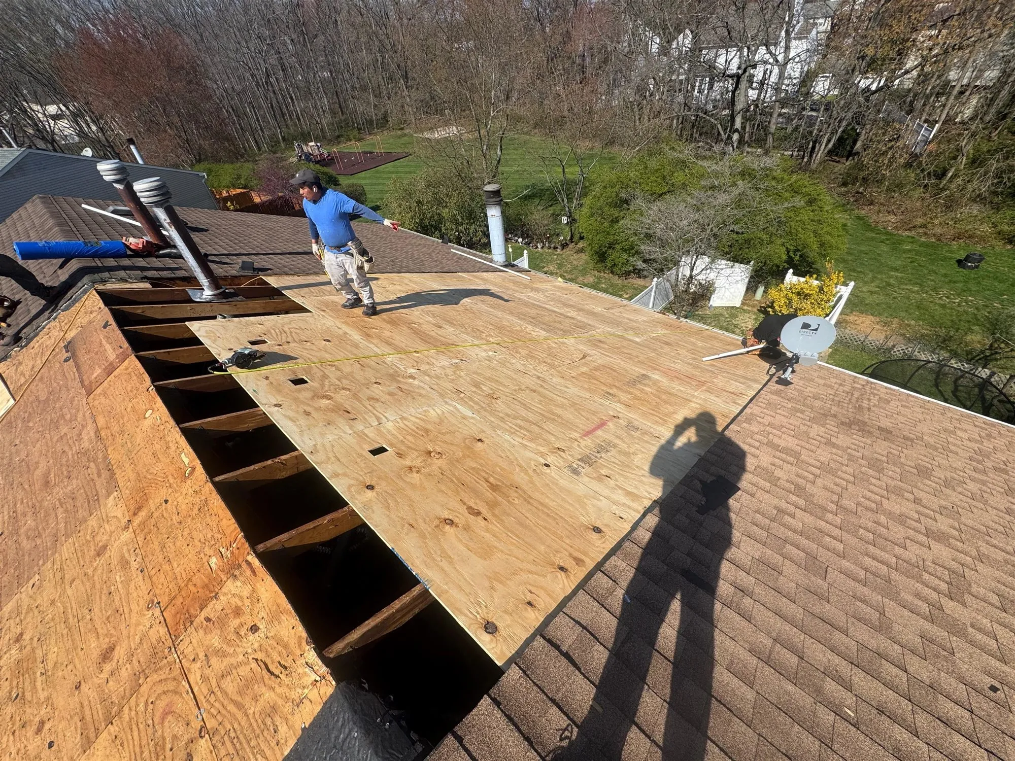 During: new plywood decking going down after the tear-off