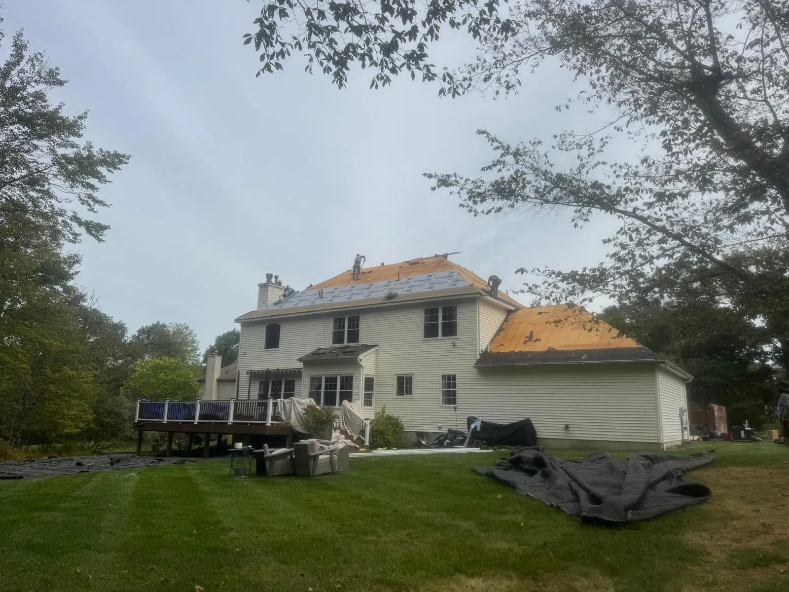 Two-story house mid re-roof with new decking and underlayment going on