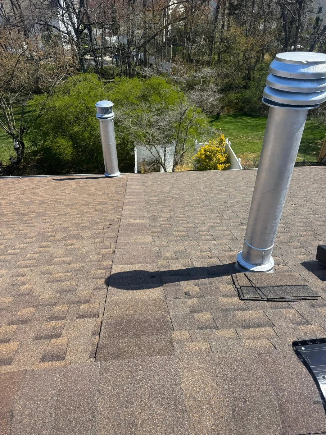 Vent pipes and rubber pipe boots on a shingle roof