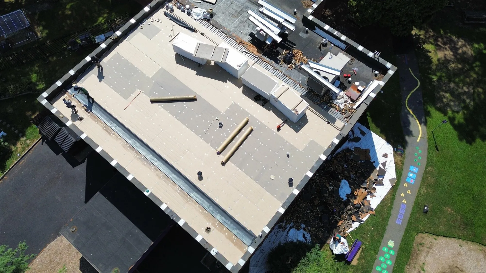 Aerial view of a commercial flat roof being re-roofed